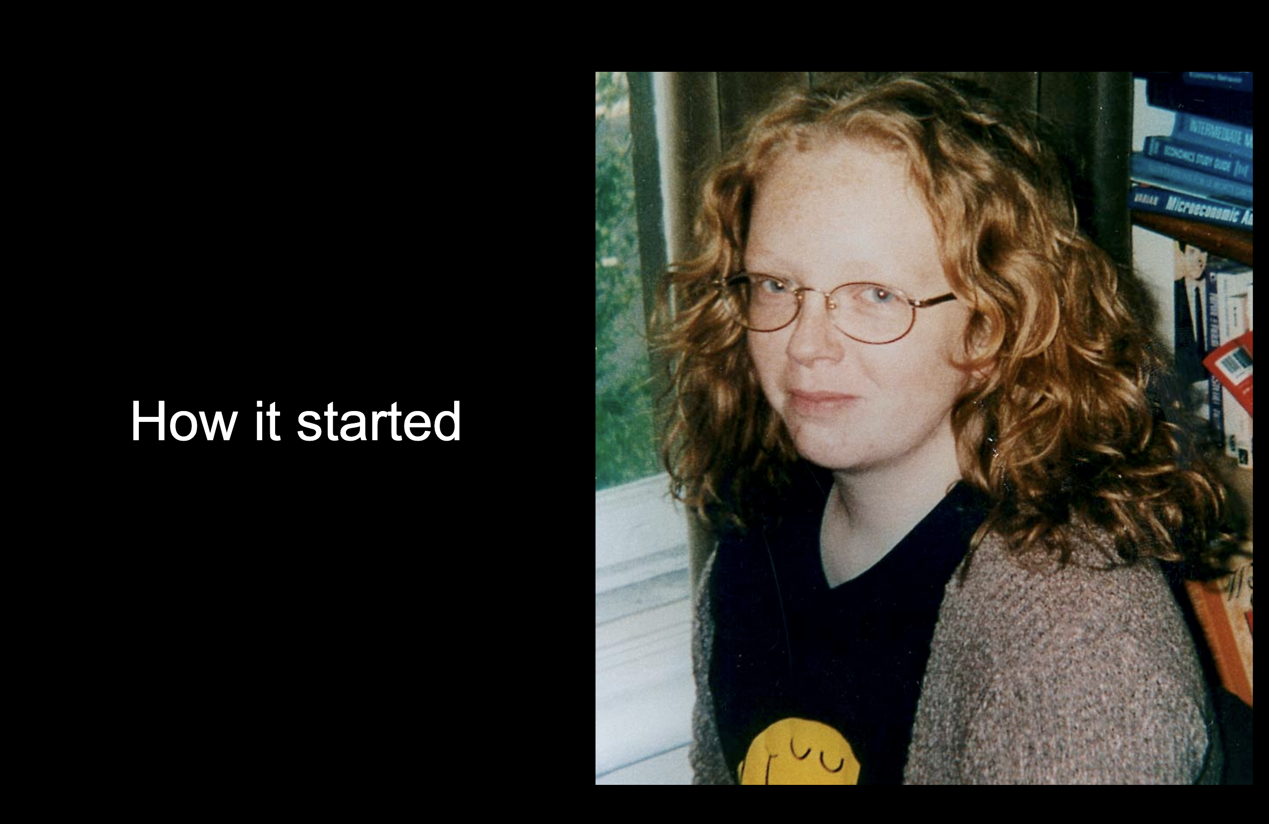 A picture of Libby in front of a load of economics books, wearing a Mr Happy tshirt and entitled how it started