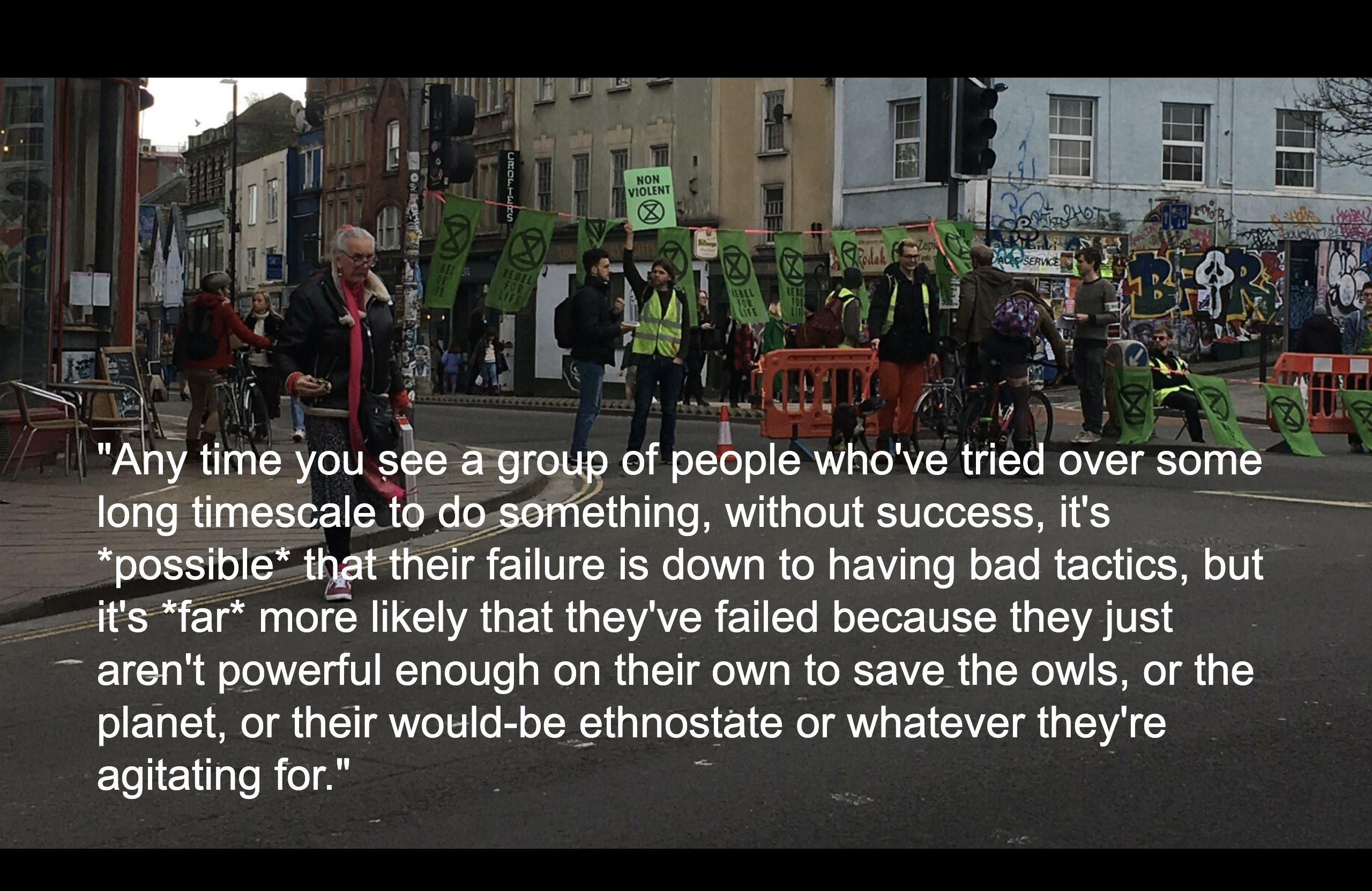 An Extinction Rebellion protest on Stokes Croft with the quote below written on top of it
